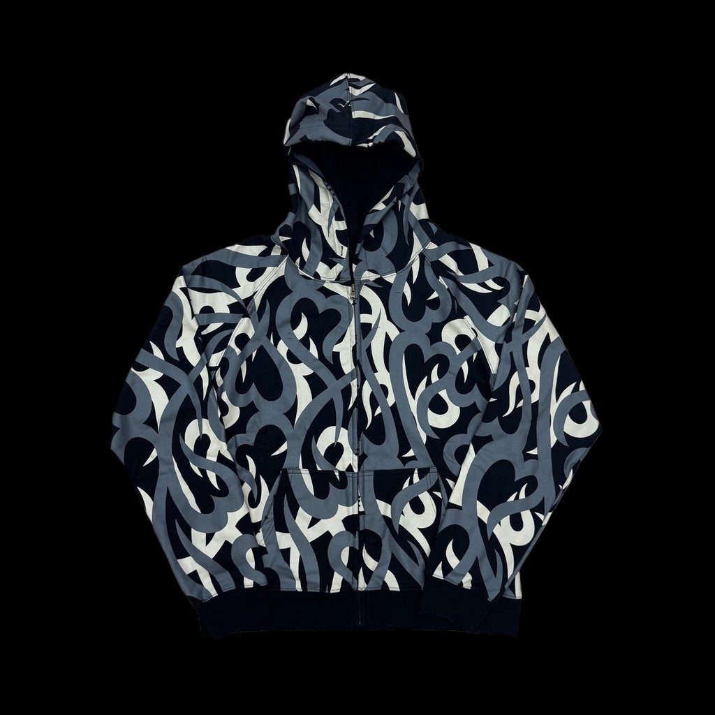 Number (N)ine zip-up jacket with tribal camo and heart patterns in faded wash cotton fabric