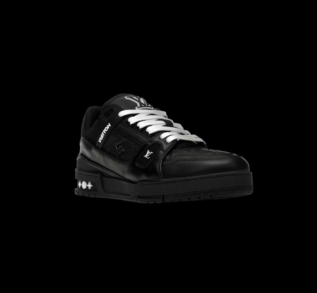 Black Louis Vuitton Trainer sneaker with embossed monogram and white laces on black background