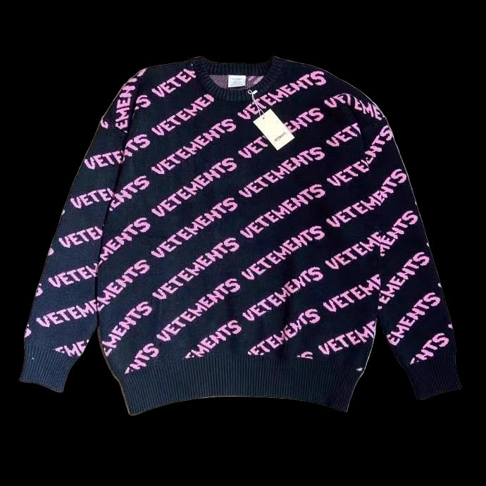 A black Vetements sweater with a relaxed fit and ribbed cuffs, made from heavyweight cotton.