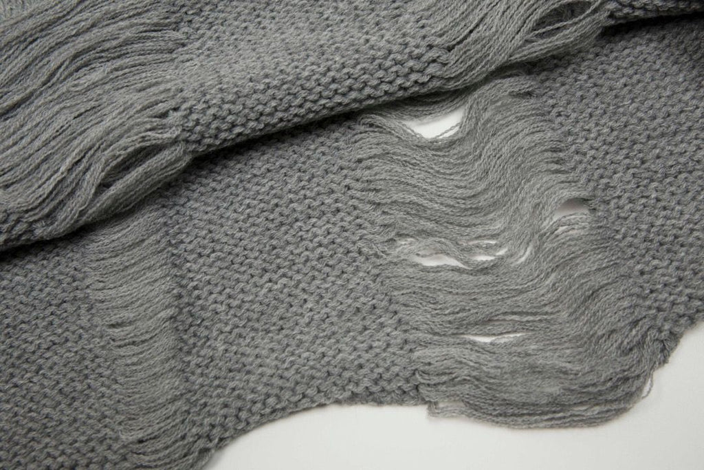 A vintage-inspired distressed knit with a ribbed crewneck and short sleeves in faded wash.