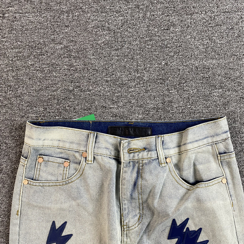 Faded gradient jeans featuring a lightning bolt design and a relaxed fit.