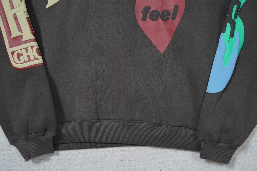 CPFM Lucky Me I See Ghosts hoodie with graphic details on sleeves and chest.