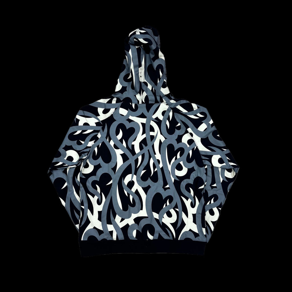 Tribal camo zip-up jacket featuring heart patterns and a vintage faded wash.