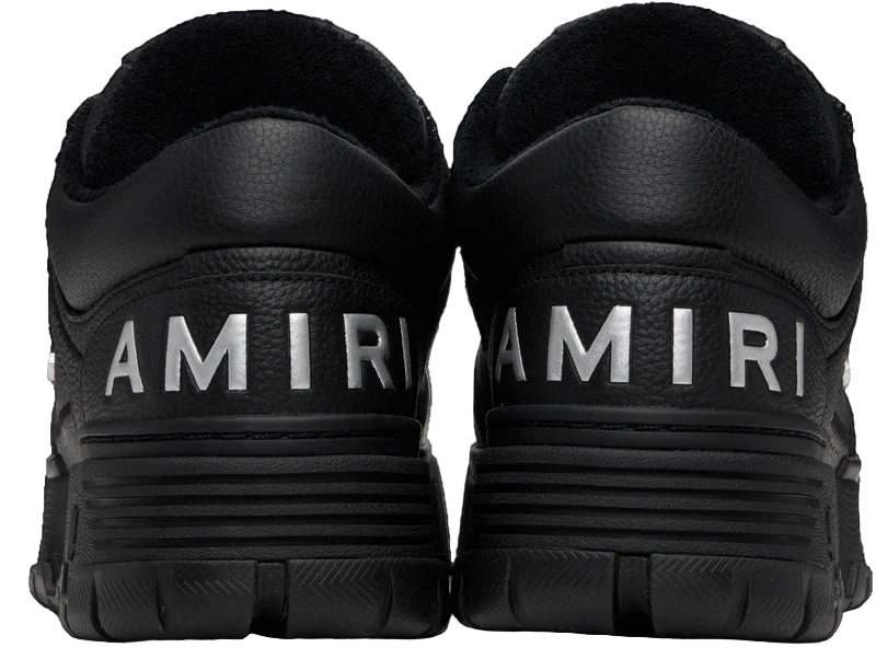 Black Amiri MA-1 sneakers with silver logo detail.