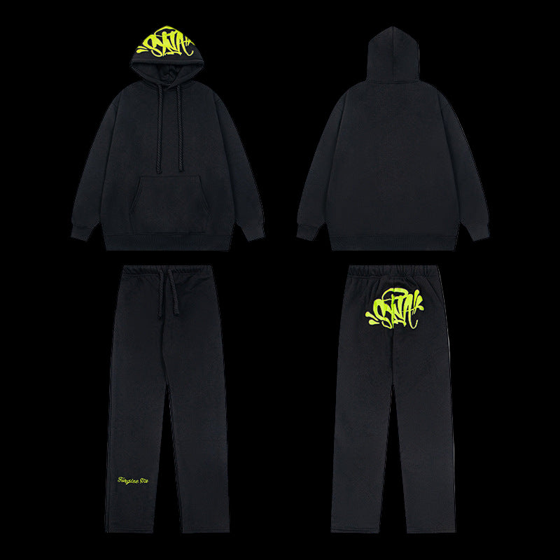 Black Syna World tracksuit with yellow logo on hoodie and pants.