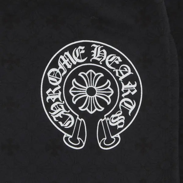 Black sweatpants with faded wash and Chrome Hearts horseshoe logo on the leg