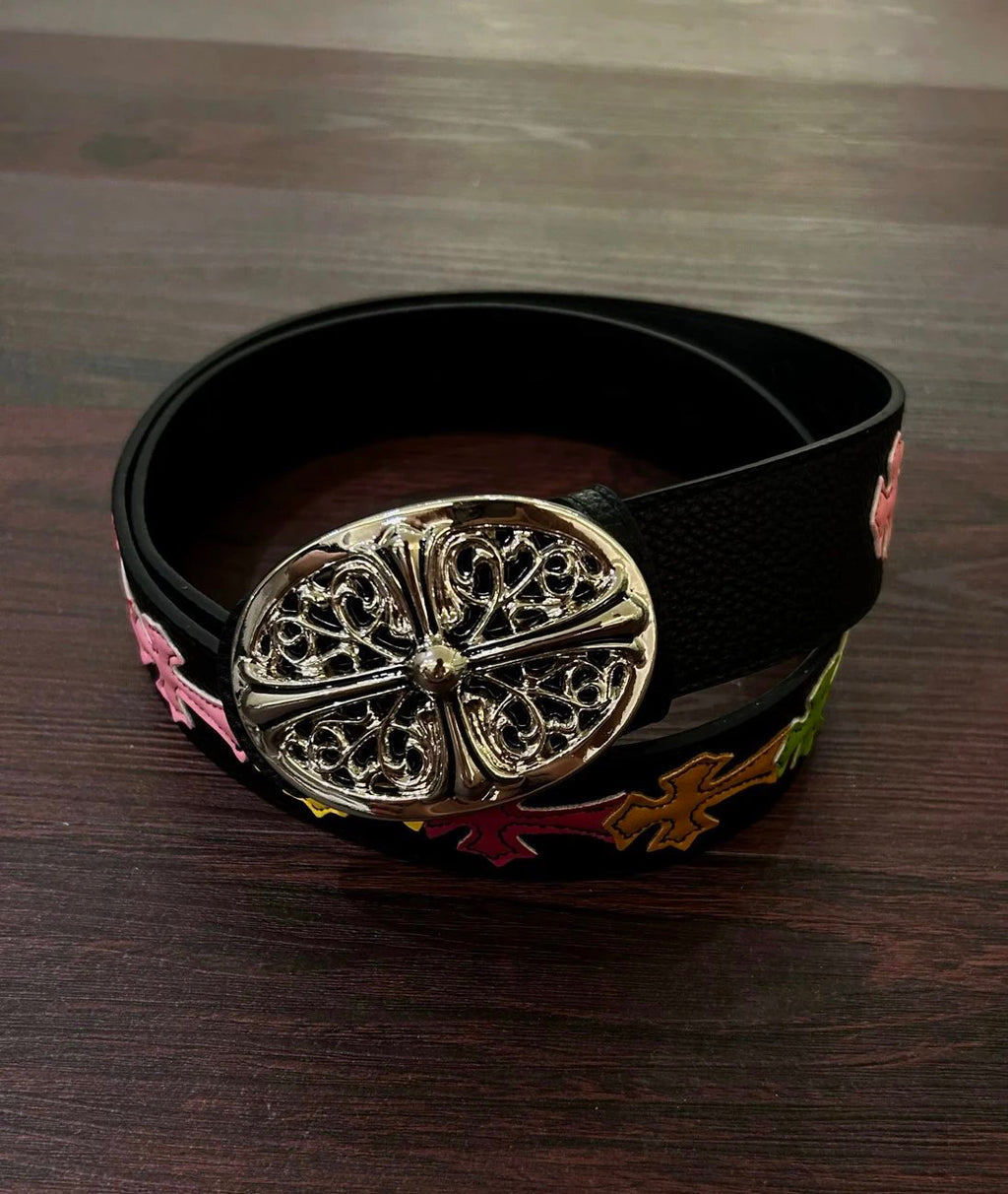 A multi-coloured belt featuring a cross design with a vintage faded wash.