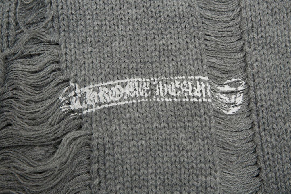 Distressed knit sweater in faded wash with ribbed crewneck and short sleeves.