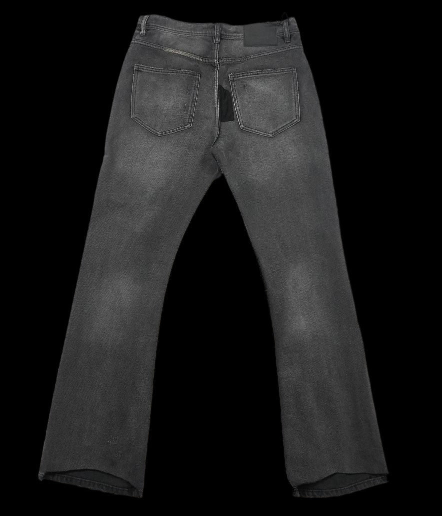 Enfant Riches Déprimés flared denim jeans with a black patchwork detail.