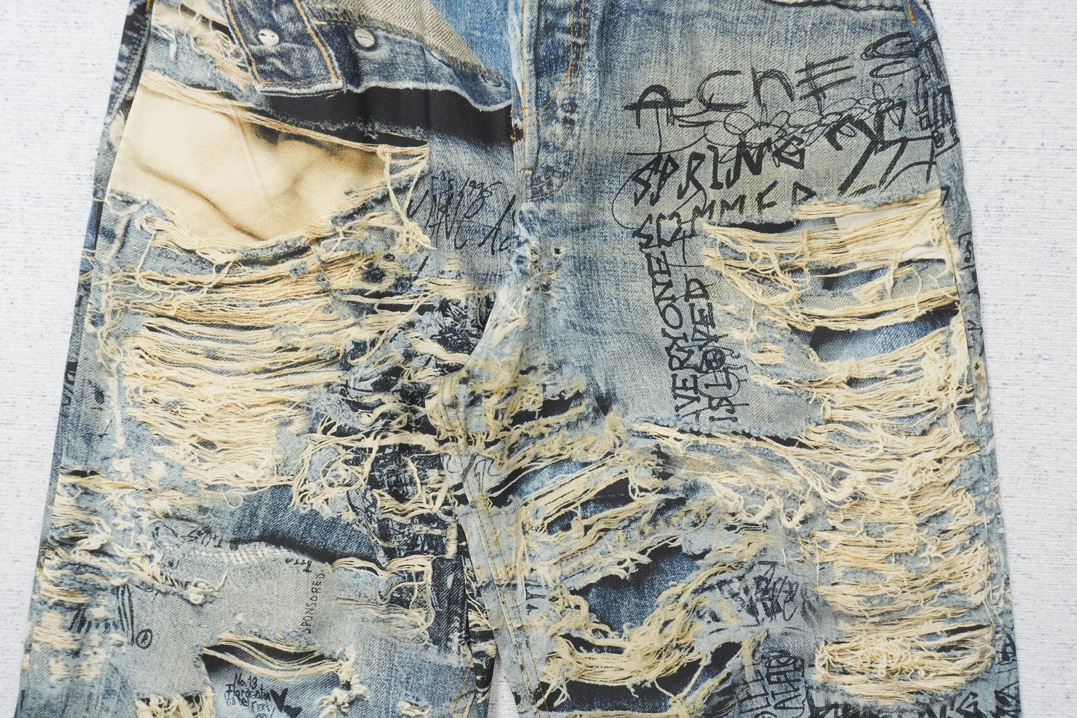 Acne Studios 2023m torn scribble trompe l'oeil denim jeans.