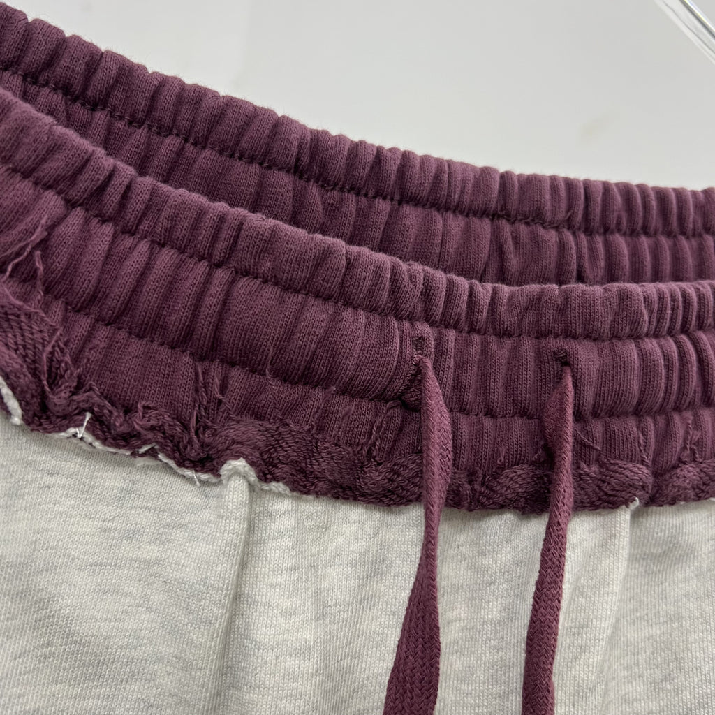 Gray distressed sweatpants with a relaxed fit and ribbed waistband.