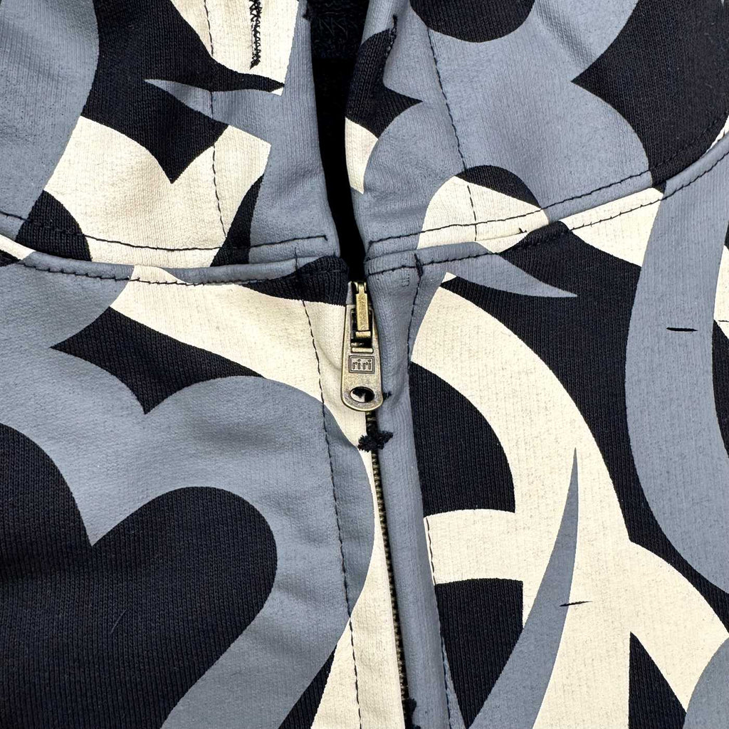 Tribal camo zip-up jacket with heart patterns and a vintage faded wash.
