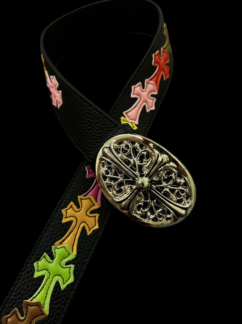 Multi-coloured belt featuring a cross design and a vintage-inspired faded wash.