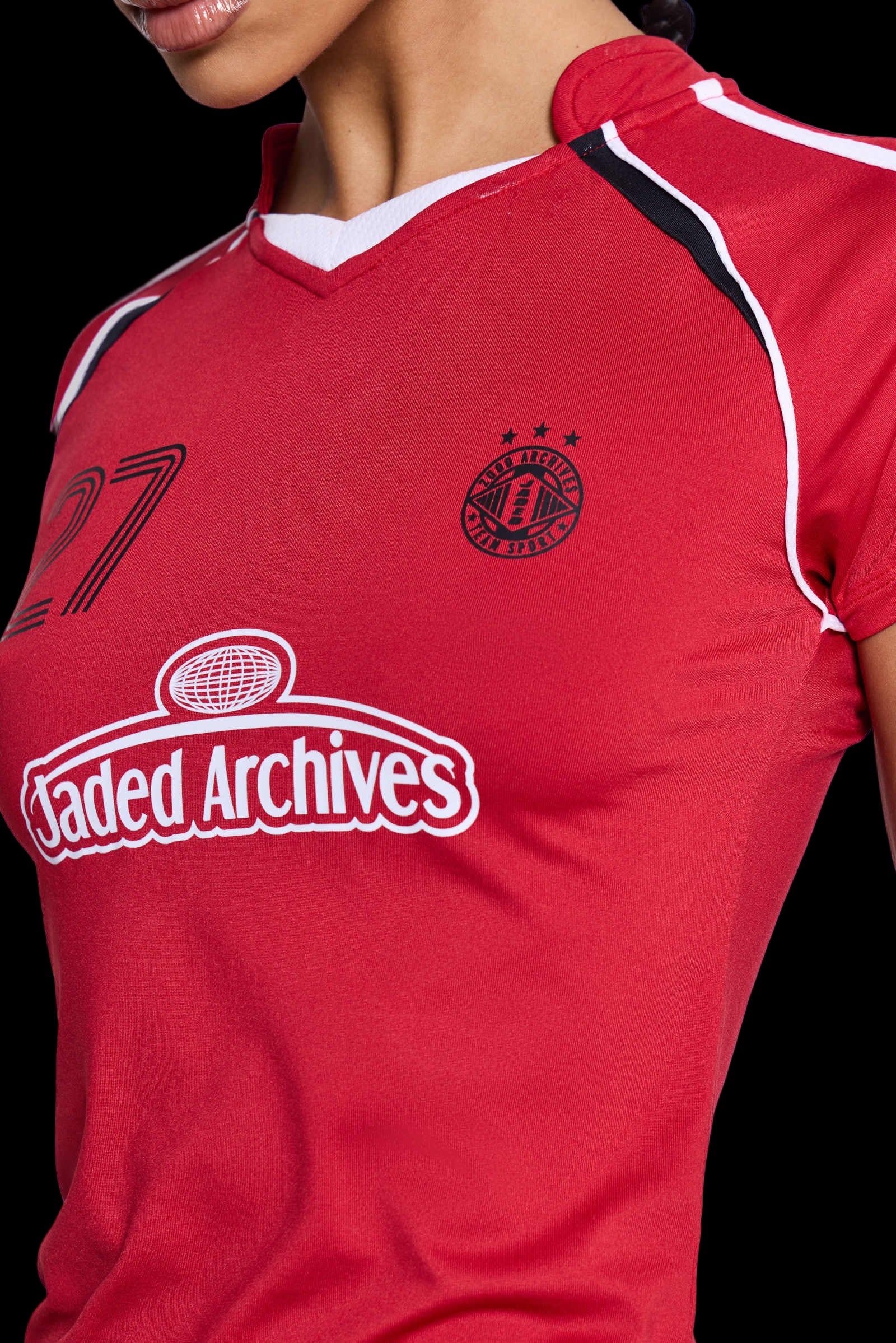 Red two-piece football set with varsity stripes, crop top, and shorts for a relaxed fit.